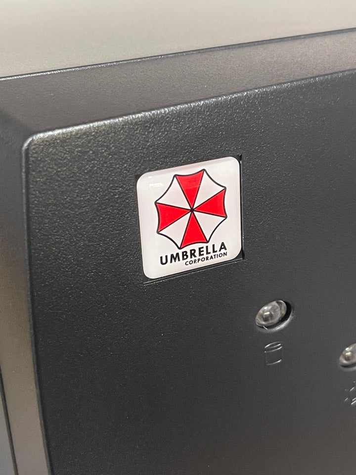 > Umbrella Corporation < Resident Evil Case Badge Sticker - Dome White